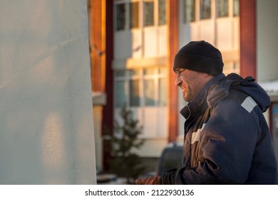 Fitter In A Blue Hooded Jacket At An Ice Slab Installation