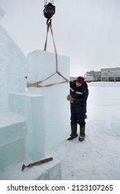 Fitter In A Blue Hooded Jacket At An Ice Slab Installation