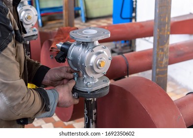 Fitter installs a gas shutoff valve in the boiler room.