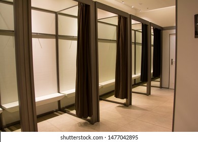 

Fitting Room In A Large Clothing Store With Brown Curtains And Mirrors