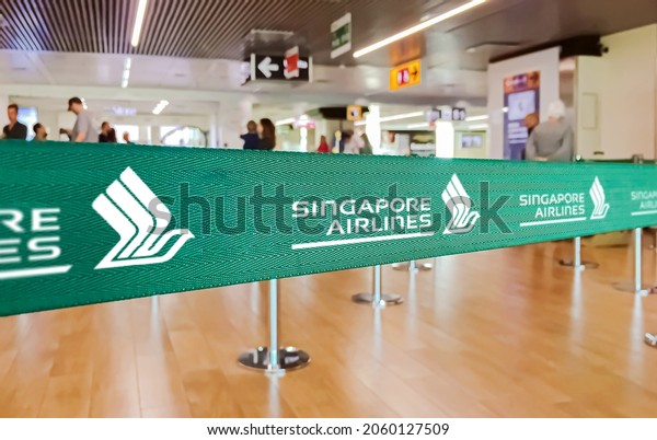 Fiumicino, Italy, July 2019:\
green ribbon barrier with the Singapore Airlines airline logo\
inside the Leonardo da Vinci international airport in Rome\
Fiumicino in Italy