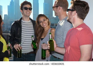 Five Adult Friends Drinking Beer At Rooftop Bar With Los Angeles Skyline, USA