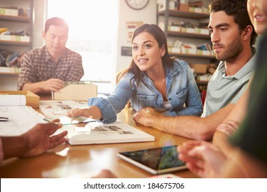 Five Architects Sitting Around Table Having Meeting - Powered by Shutterstock