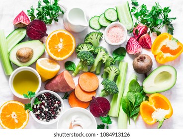 Five best vitamins for beautiful skin. Products with vitamins A, B, C, E, K - broccoli, sweet potatoes, orange, avocado, spinach, peppers, olive oil, dairy, beets, cucumber, beans. Flat lay, top view 