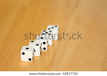 five black and white dice on a wooden background
