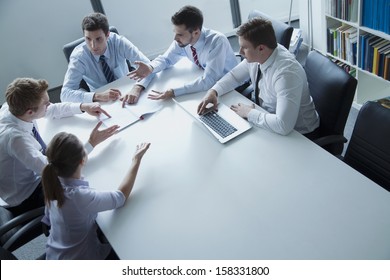 Five Business People Having Business Meeting At The Table