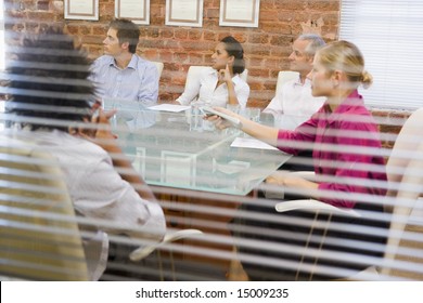 Five businesspeople in boardroom through window - Powered by Shutterstock