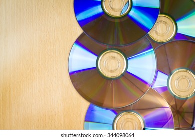 Five CDs on the wooden table / background texture