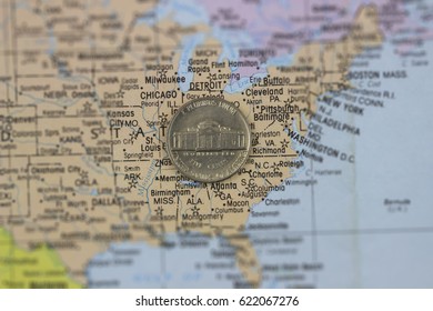 A five cent coin on a map of the United States of America