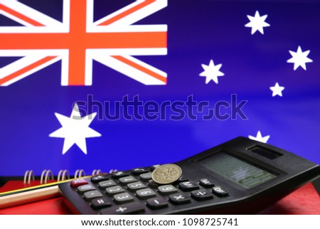 Five Cents Coin Of Australia On The Calculator With Pencils On The Red Floor And Blue Five Cents Coin Of Australia On The Calculator With Pencils On The Red Floor And Blue