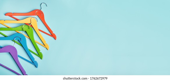 Five children's hangers for clothes of rainbow colors. Blue background. - Shutterstock ID 1762672979