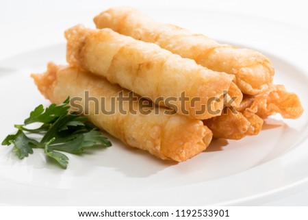 Five Cigar Pastries on a white plate and background.