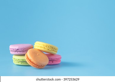 Five Colorful Macaron On Blue Plain Background