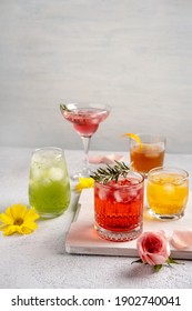 Five Colorful Summer Cocktails In Glasses On  White Table. Assortment Of Fresh  Summer Drinks. Pink And Red Sangria Cocktails, Orange Punch Cocktail, Margarita Cocktail, Tropical Mule.