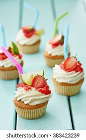 Five Decorated Pina Colada Cupcakes On The Wooden Table