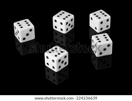 Five dice with sixes on black background with reflection.