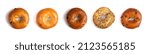 Five Different Types of Bagels on a White Background