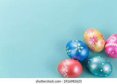Five easter eggs trendy colored classic deep blue, green, orange, magenta and golden decorated on blue background. Happy Easter card with copy space for text. Minimal style.