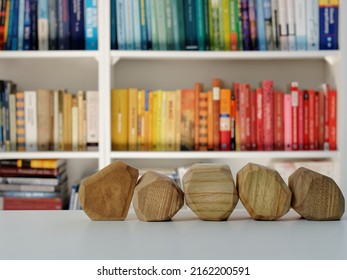 Five Empty Wooden Blocks In Front Of Home Library. Blank Wood Blocks Mockup And Blurred Bookshelf.