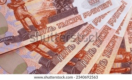 Five five-thousand-dollar bills lie in a fan. Banknotes of 5000 rubles. The Russian national currency. Background of money. Cash banknotes. Background of cash ruble notes. Financial business concept.