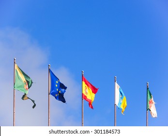 Five flags isolated on blue sky
