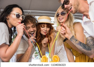 Five Freinds Are Drinking Cocktails On A Yacht And Having Fun