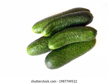 five fresh cucumbers stacked stack isolated on white background