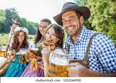 Five friends having fun on Bavarian RIver with beer glasses.