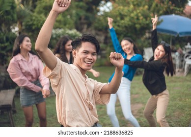 Five friends having fun partying at the garden. Focus on the sole male with four women behind. - Shutterstock ID 2188636825