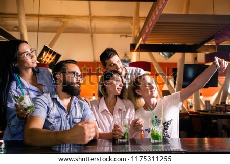 Similar – Multiethnic friends resting outside food truck in evening