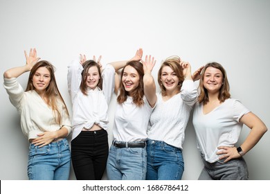 Five Girlfriends In Similar Clothes Pose With Different Emotions In The Studio