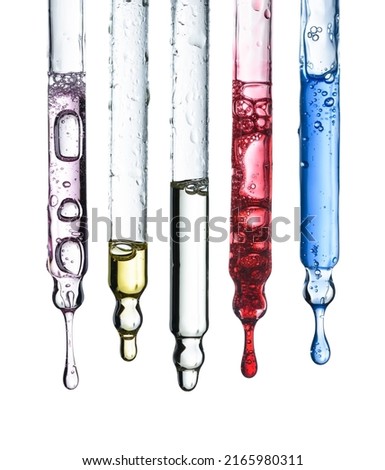 Five glass cosmetic pipette droppers set with different colored skincare serum and hanging liquid drop, isolated on white background