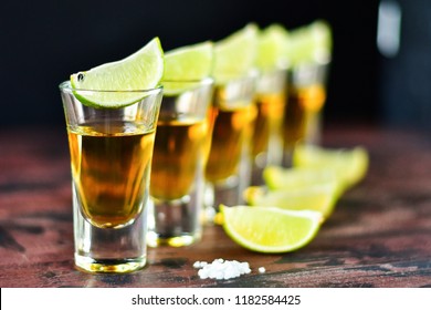  five glasses of alcohol and lime and red chili, a party at the bar, a menu for the bar. Selective focus and copy space, Tequila shots, vodka,whisky, rum