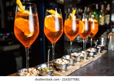 Five Glasses Of Aperol On The Bar. Aperol With Orange And Ice