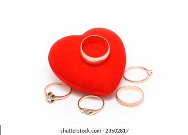 Five Gold Rings Lay Near To Red Velvet Heart