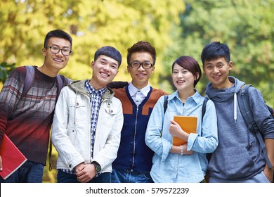 Five Happy Chinese College Students Smile At Camera In Campus