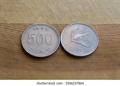 Five hundred south korean won coin on wooden background, 1983 year, 500 wons korea collectible coin,  empire, collectors, numismatic, metal money, Flying Manchurian crane and the value below in Korean