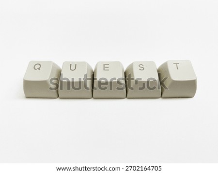 Five individual computer keycaps spelling the word QUEST are arranged in a row against a solid white background.
