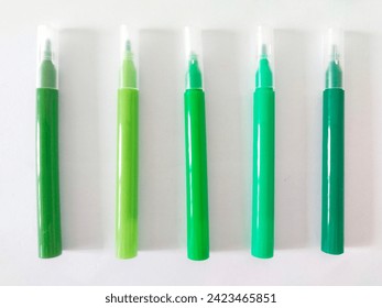 Five light and dark green markers on a white background - Powered by Shutterstock