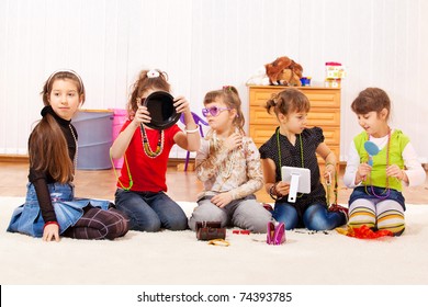 Five Little Girls Trying On Jewelry