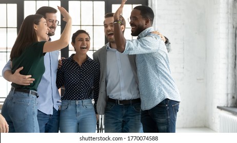 Five Multi Ethnic Students Or Company Employees Accomplish Project, Exam Pass, Embracing Feels Excited Celebrating Common Success Giving High 5, Gesture Of Unity Racial Equality And Friendship Concept