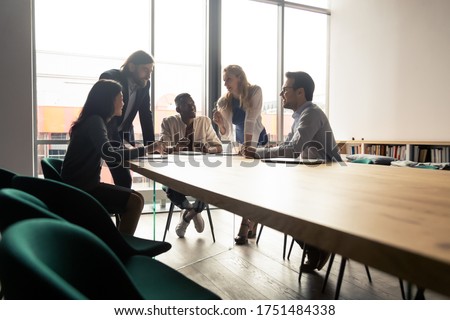 Five multinational workgroup creative team brainstorming thinking gathered in morning briefing group meeting in board room discuss ideas planning future projects solving problems together at workplace