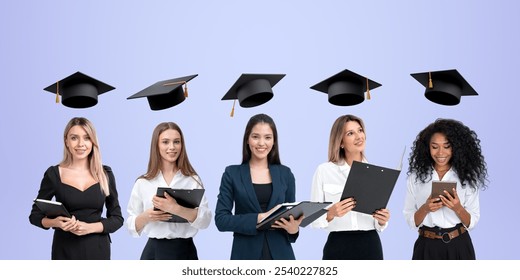 Five multiracial businesswomen portraits in row with clipboard and devices. Dreaming and smiling students with graduation cap above heads. Concept of career development, education and degree - Powered by Shutterstock