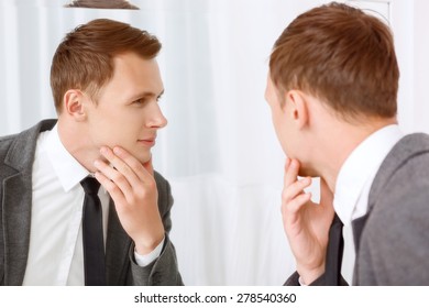 Five Oclock Shadow. Young Man Looking In Mirror And Checking His Bristle Hair On Face.