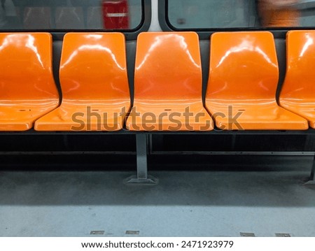 Five orange subway empty seats. Train seat. Rail public transportation system. No people, nobody. Horizontal photo. Metro. 