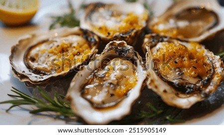 Five oysters with a yellow sauce on top. The sauce is made from butter and lemon juice. The oysters are arranged on a white plate with some herbs and lemon slices