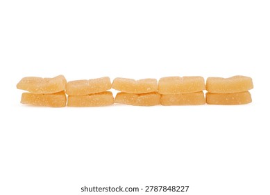 Five pairs of light orange, rectangular gummy candies are arranged in a straight, horizontal row against a flat, white background. Each piece consists of a soft confectionery base coated in a fine layer of sugar crystals, creating a matte, granular texture across the entire surface. The candies are stacked vertically into five distinct sets, maintaining even spacing between each pair. This repetitive, rhythmic alignment emphasizes the identical dimensions and finish of the individual gelatin snacks. The arrangement is illuminated by bright, uniform light from multiple directions, ensuring even brightness across the subjects. The neutral white surface provides a clean backdrop, free of architectural markers or environmental distractions. Soft, diffused light minimizes hard lines, resulting in faint shadows that indicate the physical presence of the objects. These rectangular forms maintain a consistent light orange hue, while the material density appears soft and pliable against the rigid, straight edges of the stacks, creating a precise visual balance.