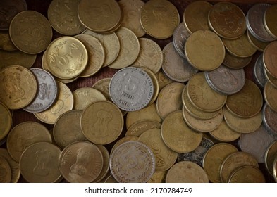Five rupees coins of India. Pile of money coins. Nickel and alloys coins of different years. Round. Written in Hindi language Bharat and five rupaya. Devnagari. 