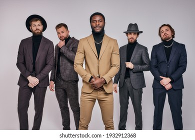 Five Serious Gangsters Stand In A Row In Studio. Retro. Indoors. Young Guys In Elegant Fashionable Fancy Suit Or Tuxedo Posing At Camera, Copy Space