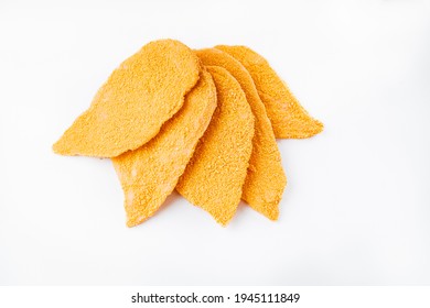 Five slices Breaded chicken schnitzel fillet sliced on a white background. Raw chicken fillet sprinkled in bright breading.